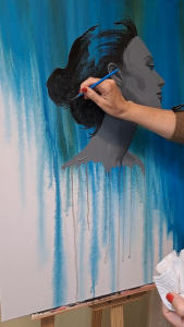 artist hand drawing on canvas a female figure